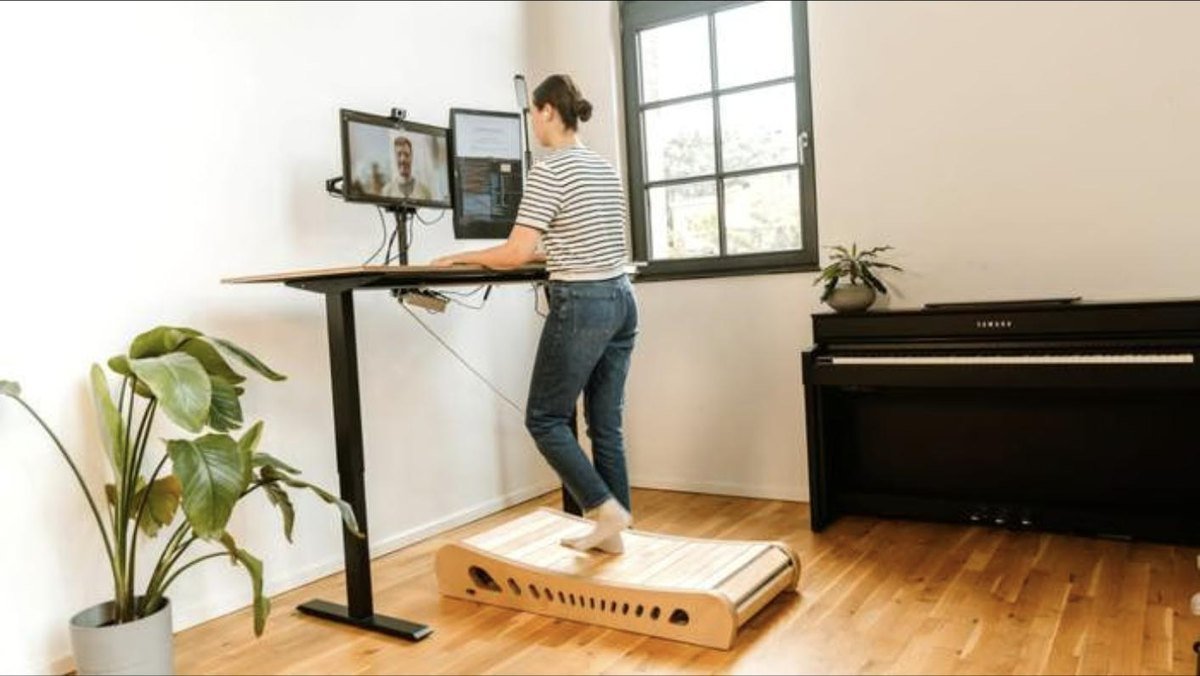 Someone walking on Office Walker at a standing desk during a video call