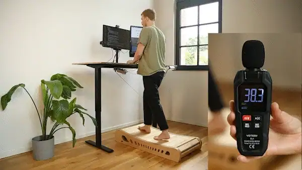 Someone walking on Office Walker at a standing desk while a sound level meter reads 38 decibels